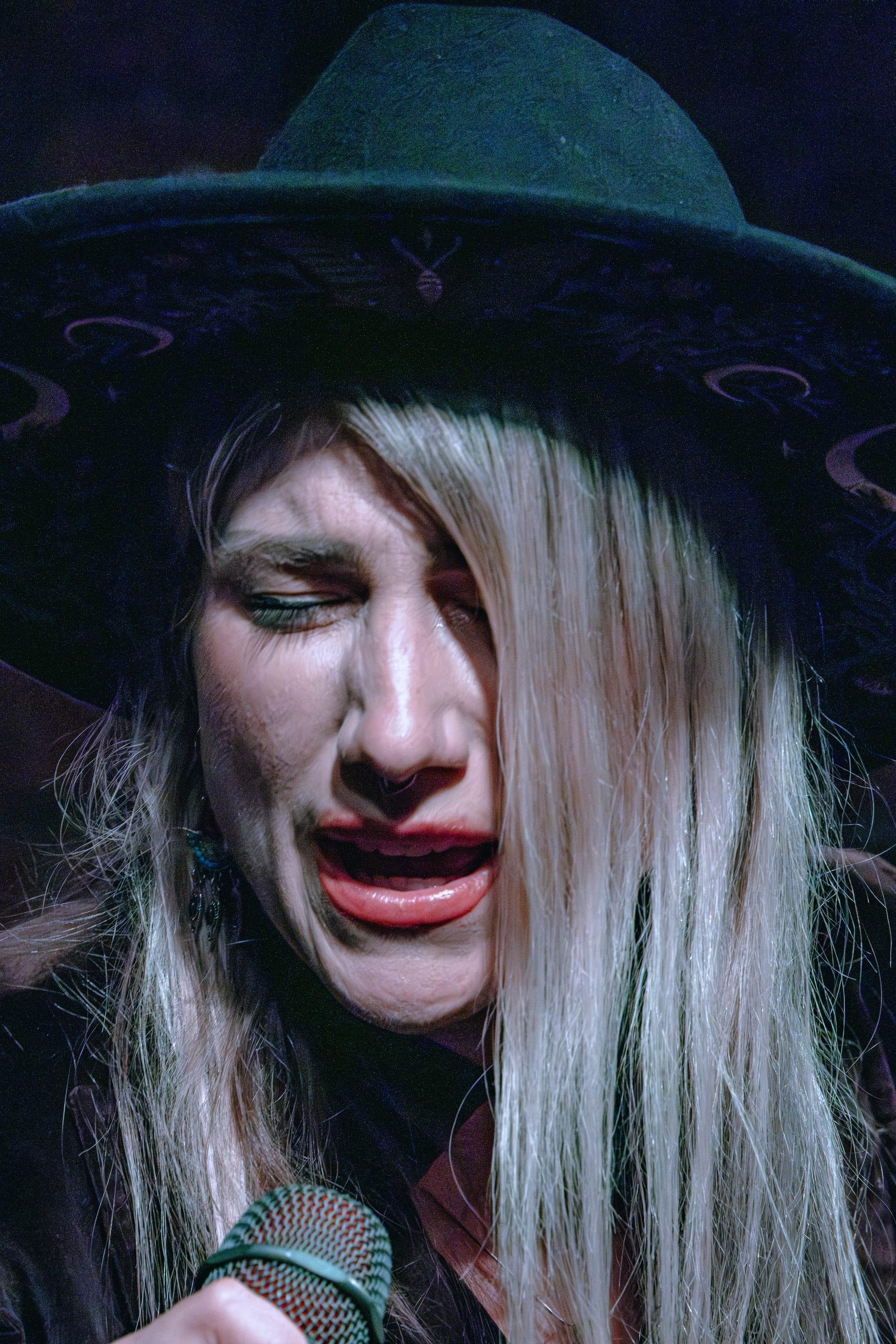 Singer with eyes closed, fully inside the song