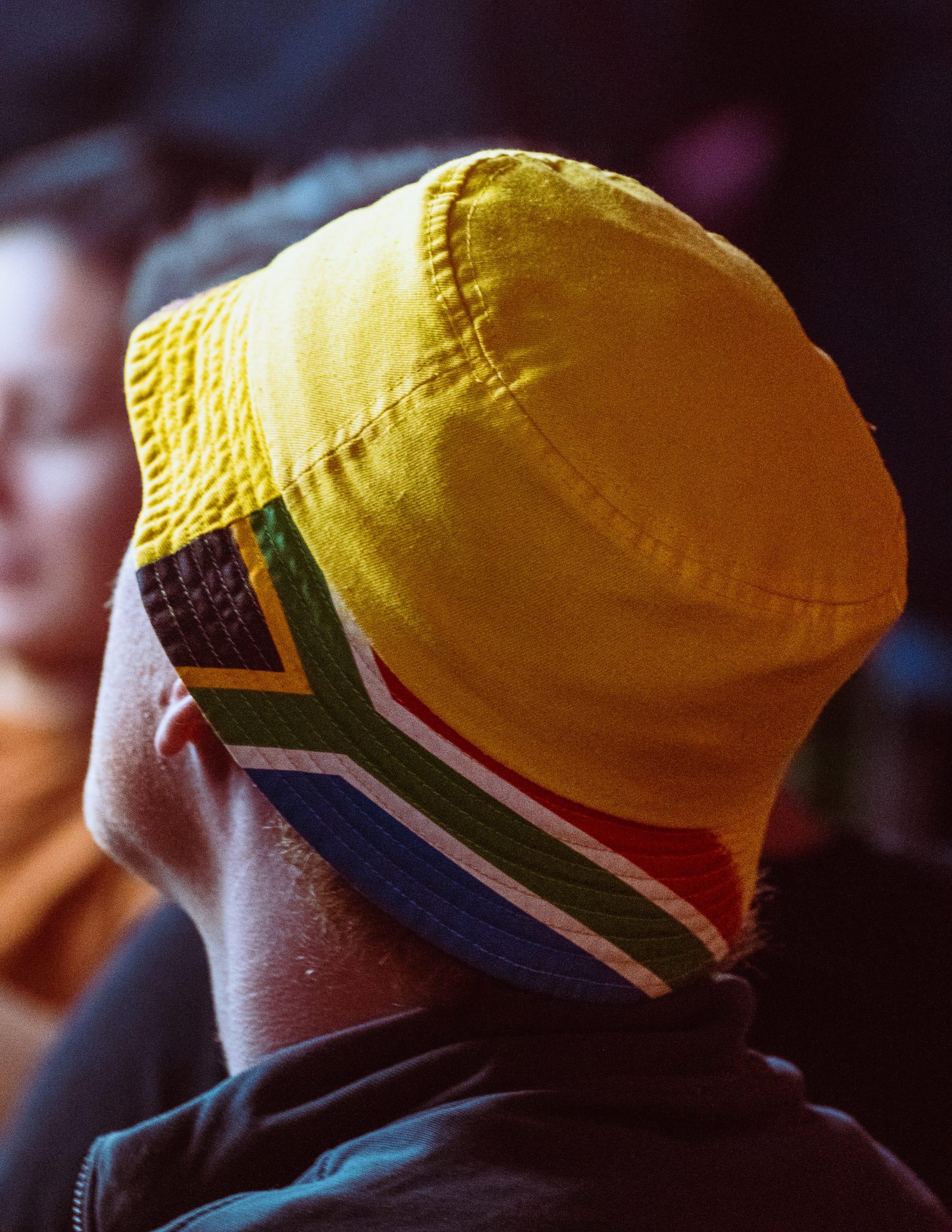 Close detail of a South Africa flag cap in the crowd
