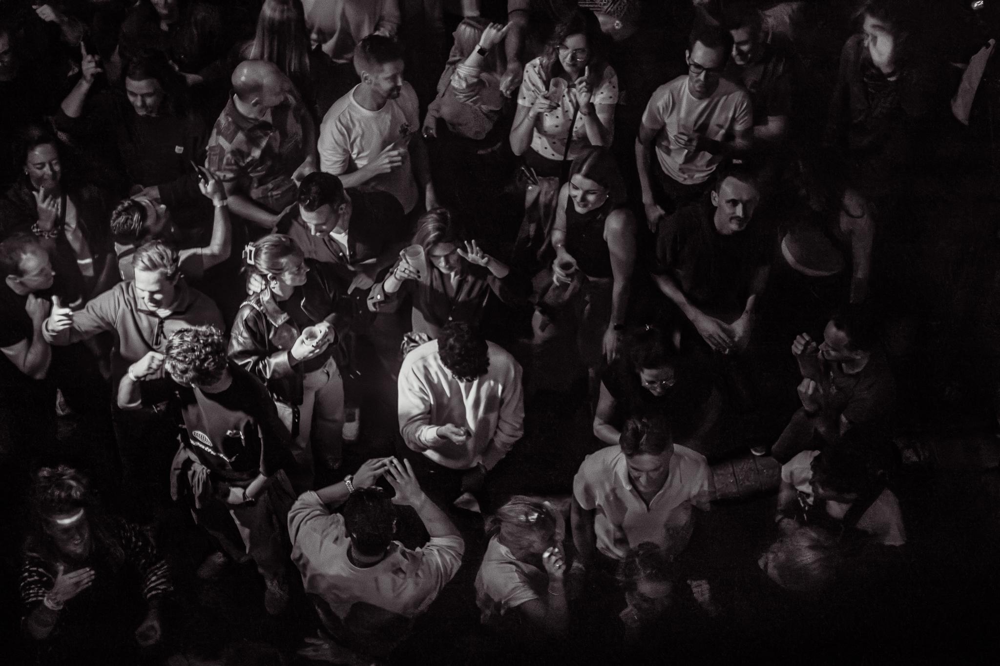 An overhead view of the crowd dancing between sets, black and white