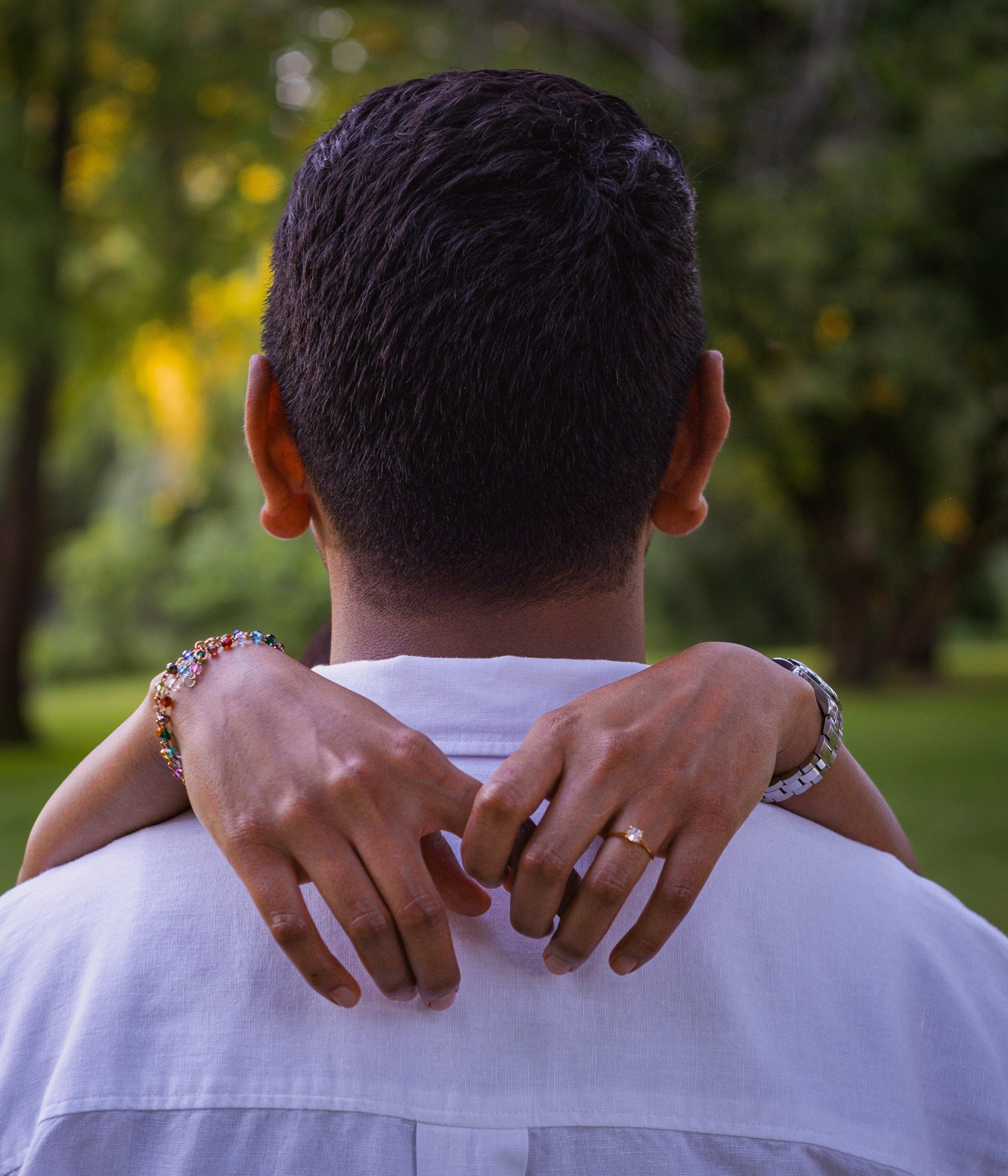 Couple walking hand in hand through a park, softly blurred