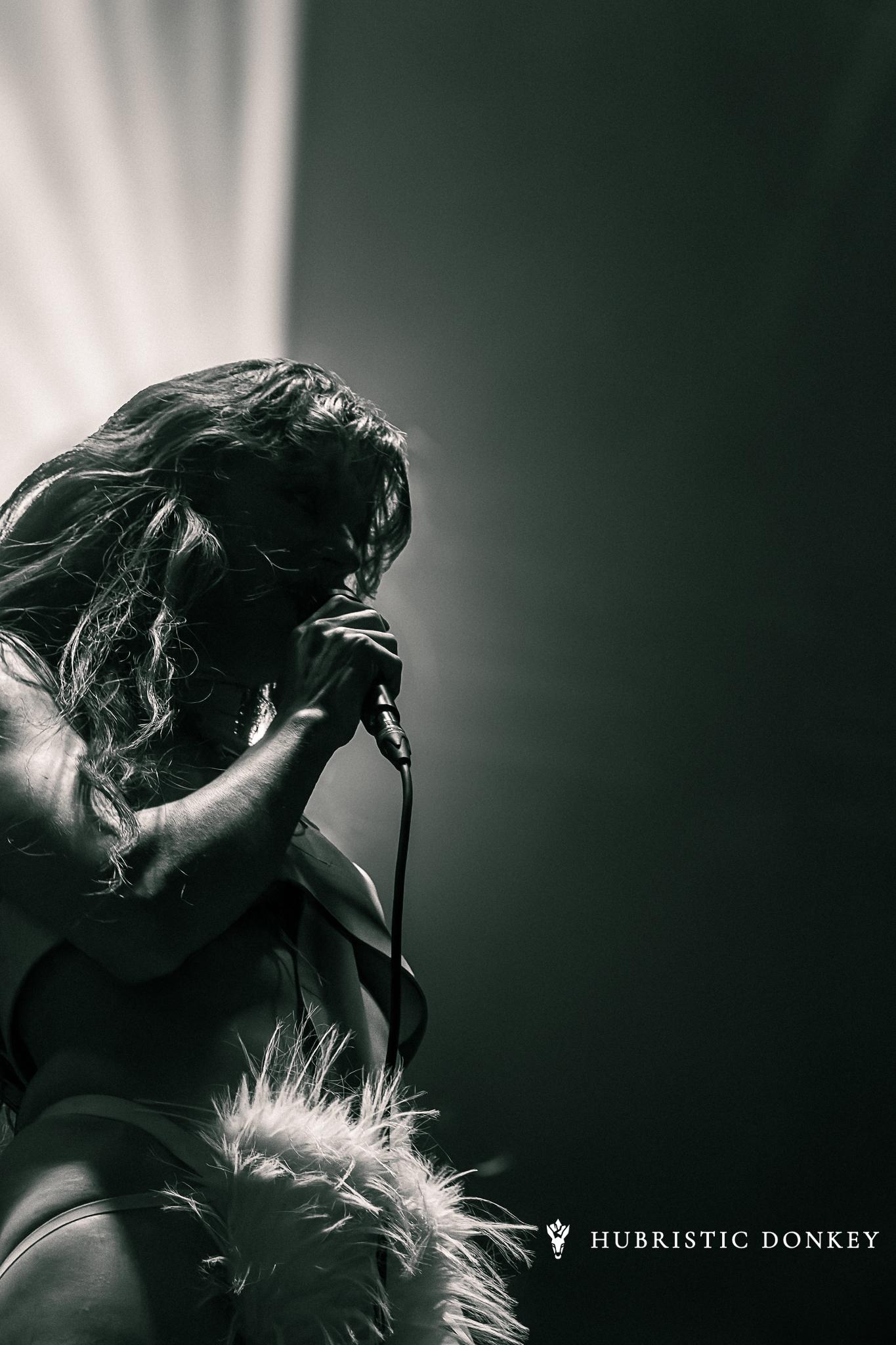 A vocalist lit dramatically on stage at Breda Barst